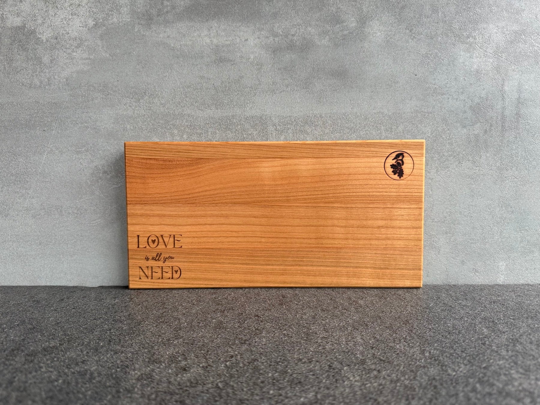 30 cm breites Brotzeitbrett aus Kirschbaum mit Laserung "Love is all you need".