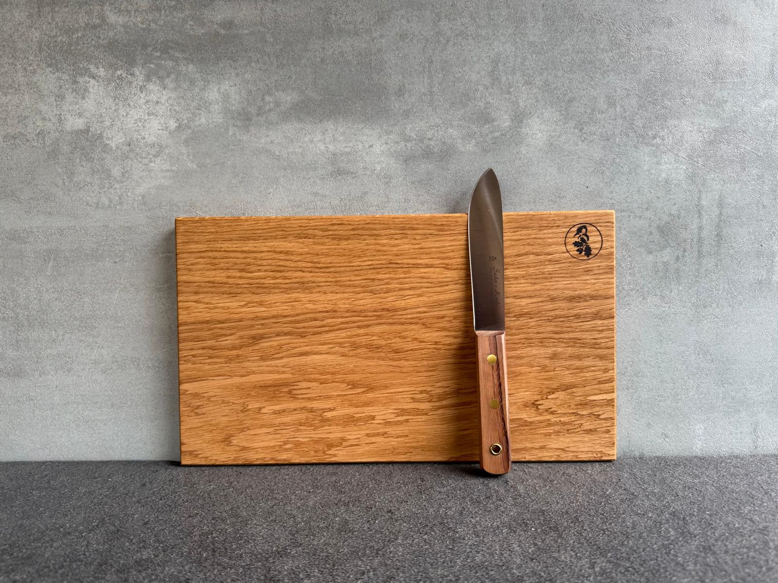 Matrosenmesser Sailor’s Knife von GÜDE liegt dekorativ an Eichenbrett aus dem Spessart bereit.