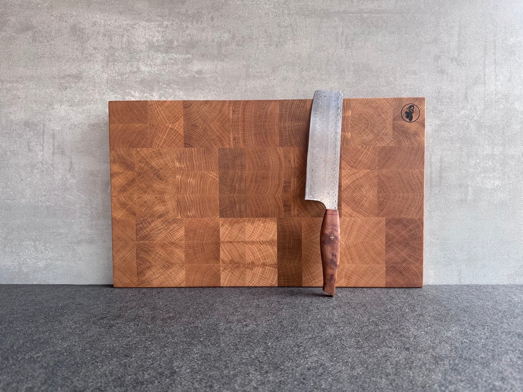 Großes Eiche Hirnholz Schneidebrett mit einem Gemüsemesser von Mainmesser dekoriert.