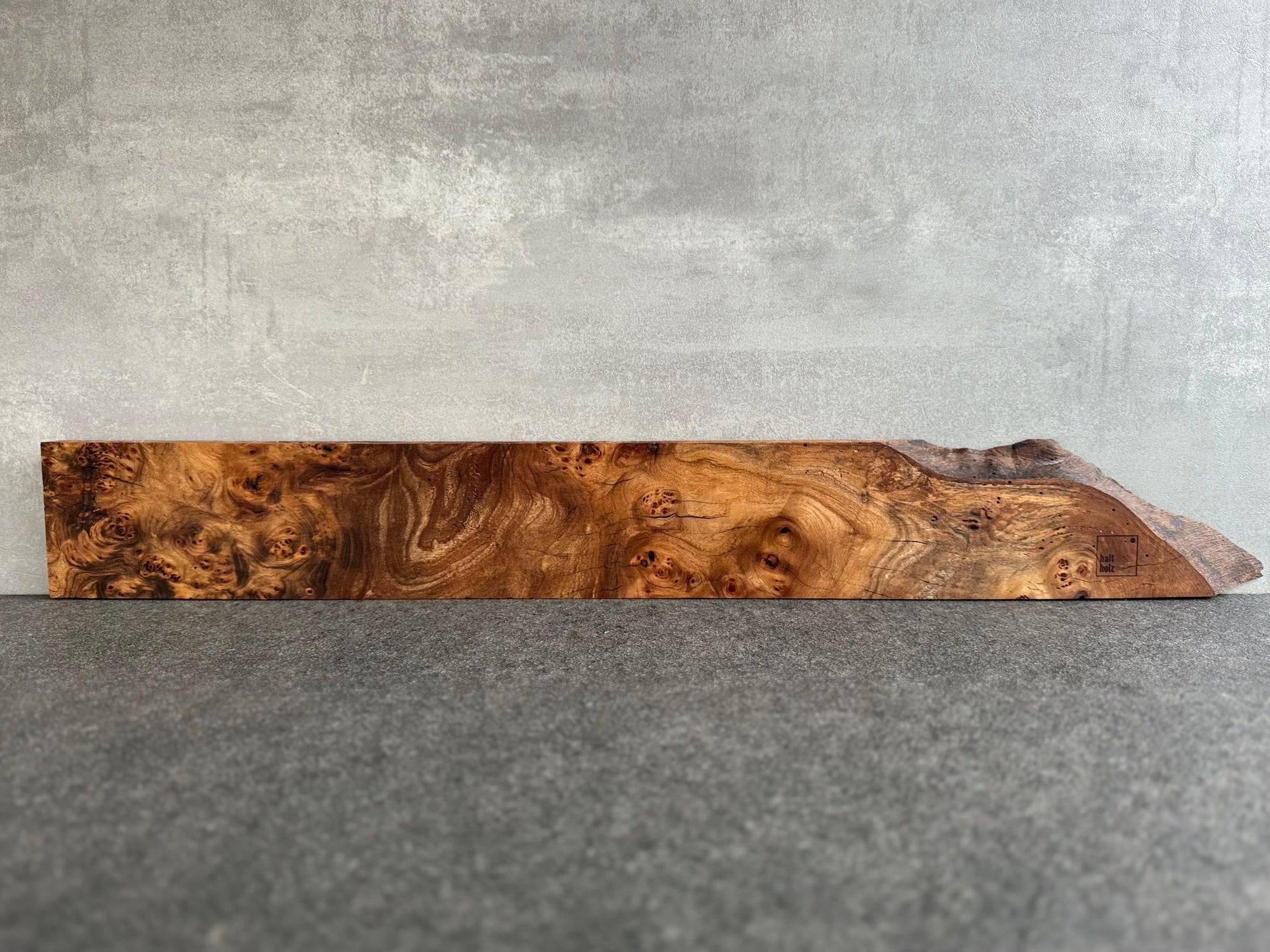 Fast 90 cm breiter Magnet Wandmesserhaltern aus Rüster mit einer kleinen Baumkante. Hat Platz für 11 Messer.