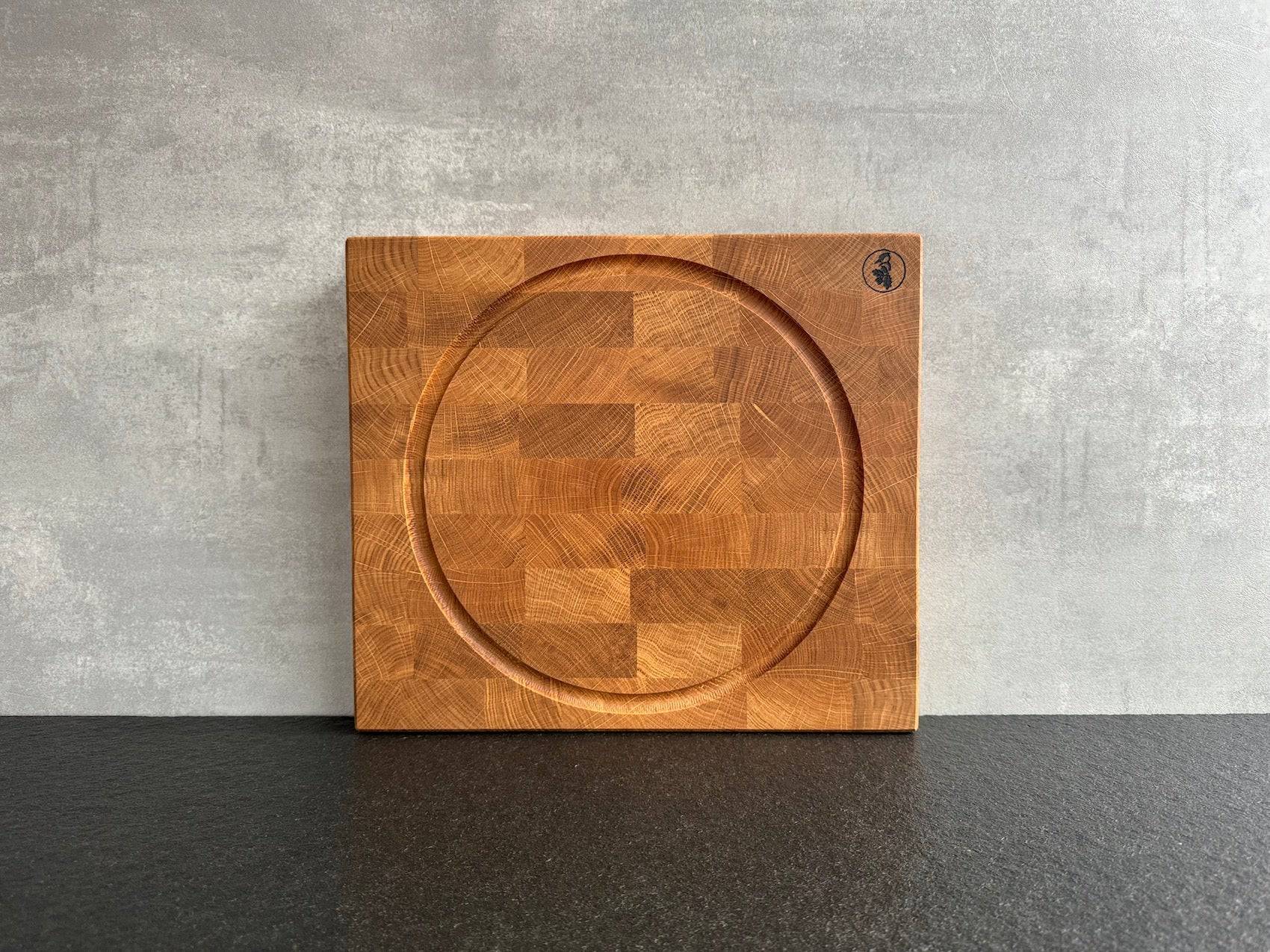 Kompakter Design Hirnholz Eiche Schneideblock mit einer kreisrunden Saftrille.
