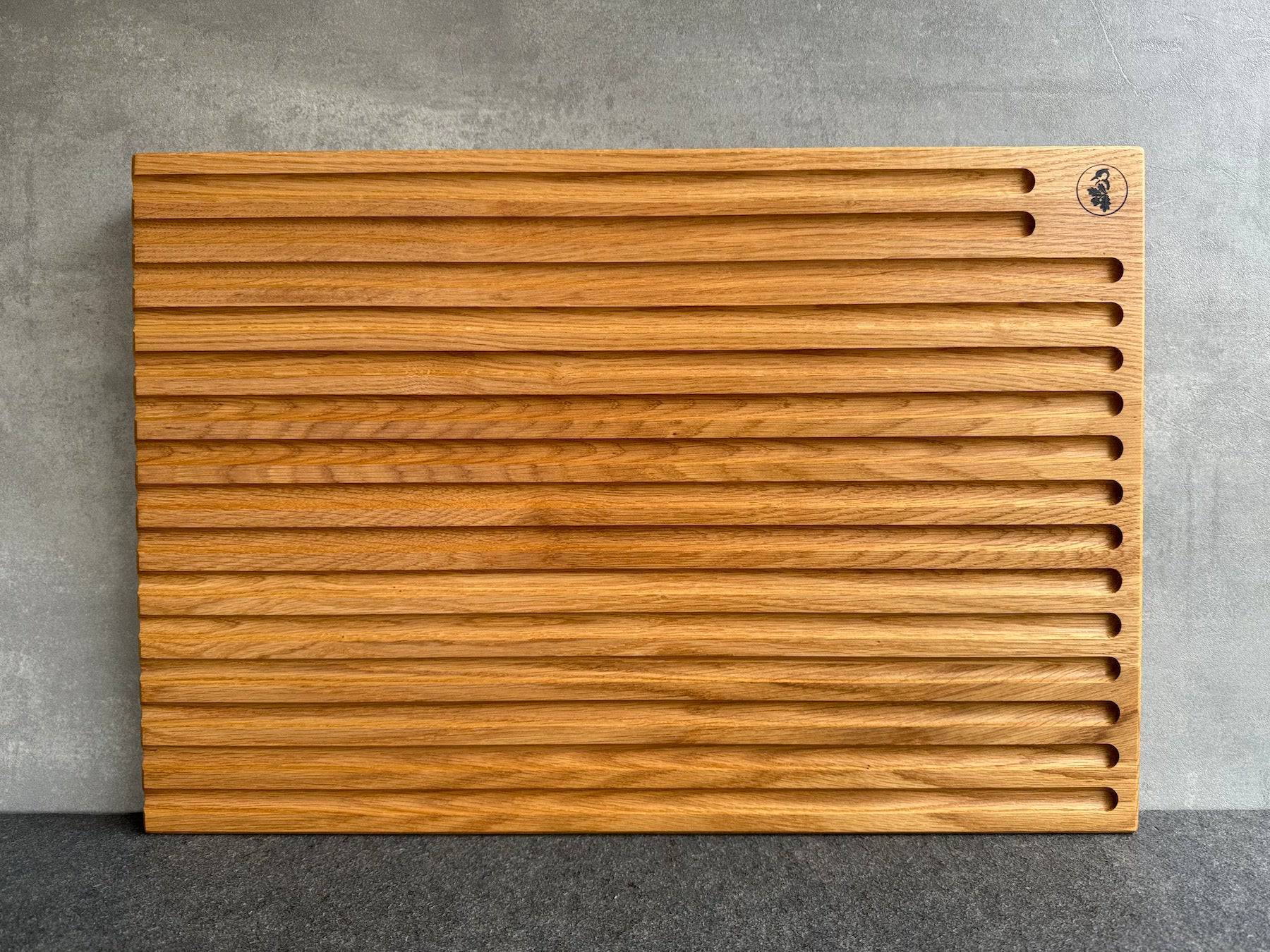 60 cm breites Brotbrett mit 15 Rillen an einer Betonwand.
