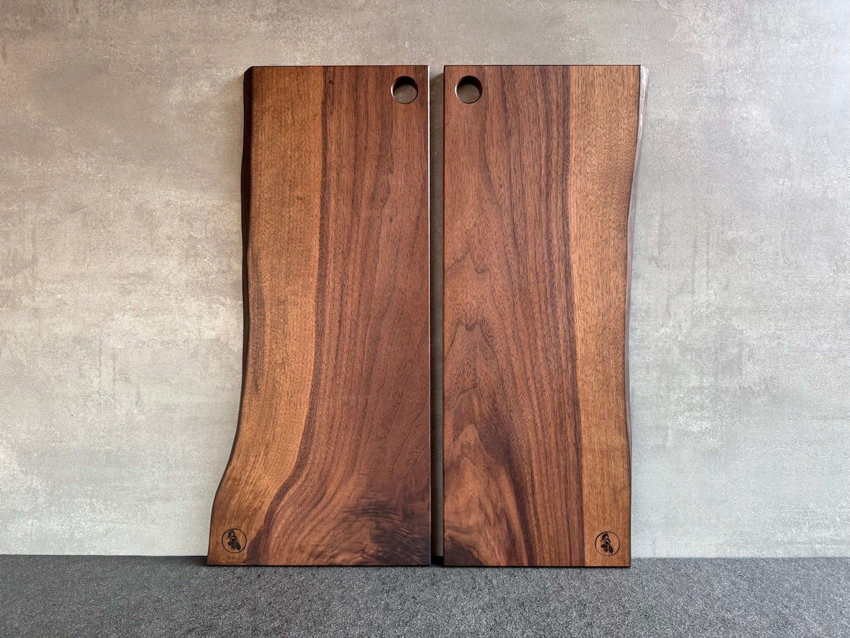 2 Servierbretter aus einer Bohle Nussbaum. 61 cm lang.