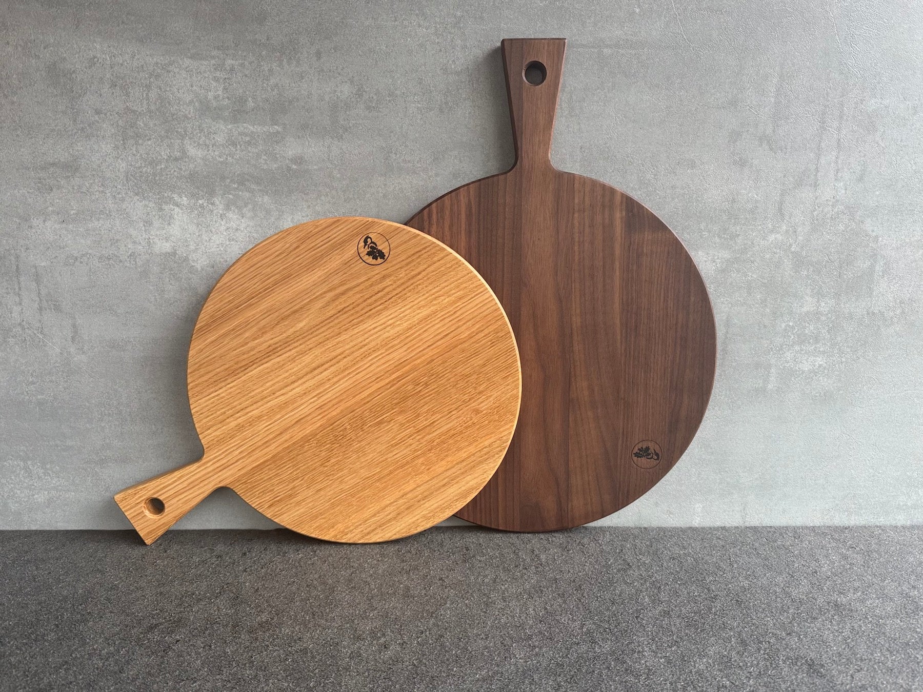 2 verschiedene Größen Pizzabrett mit Griff: 32 und 35 cm Durchmesser in Eiche und Nussbaum.