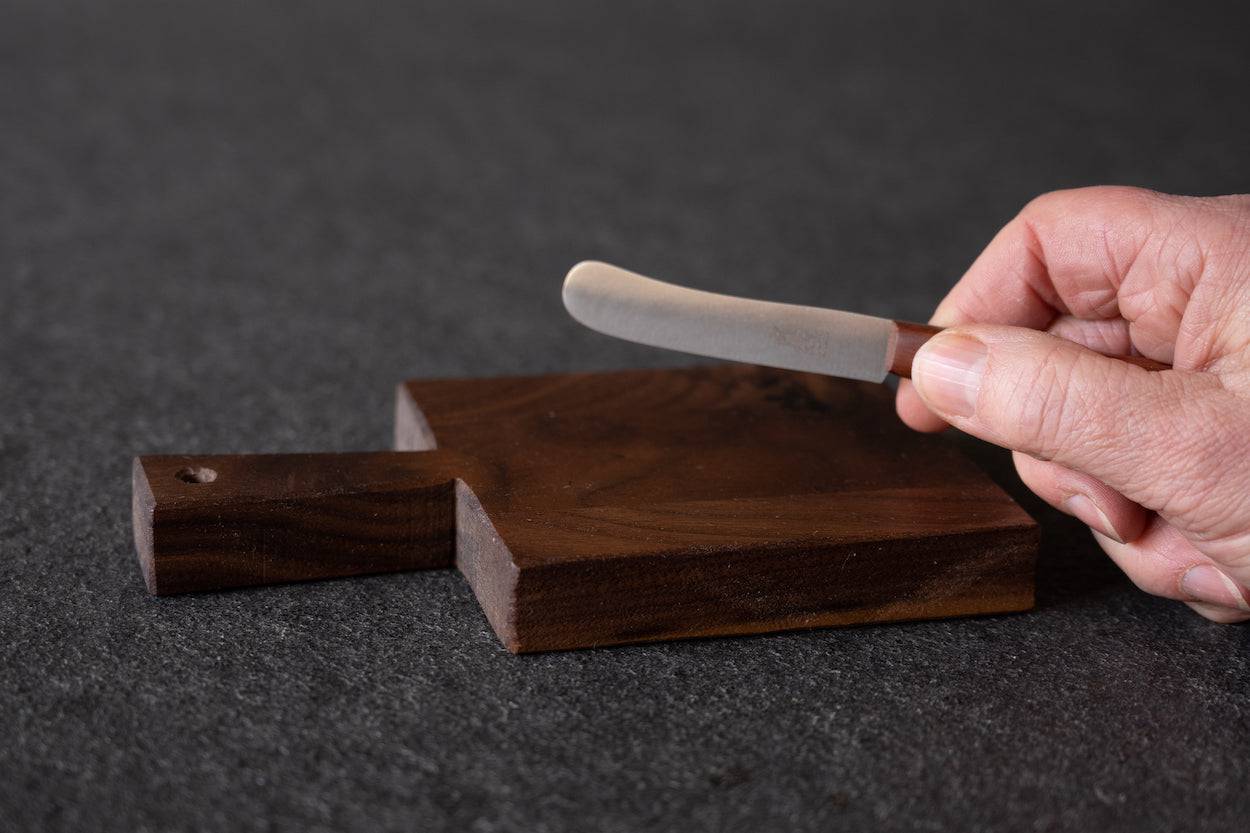 Beilegemesser Buckels für Butter in der Hand gehalten