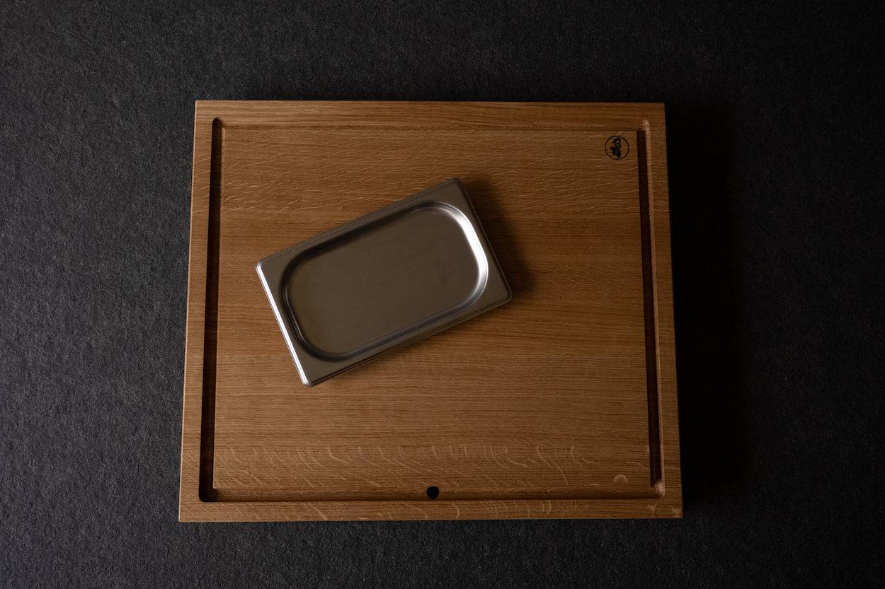 Auffangschale aus Edelstahl liegt auf Saftrillenbrett aus Eiche