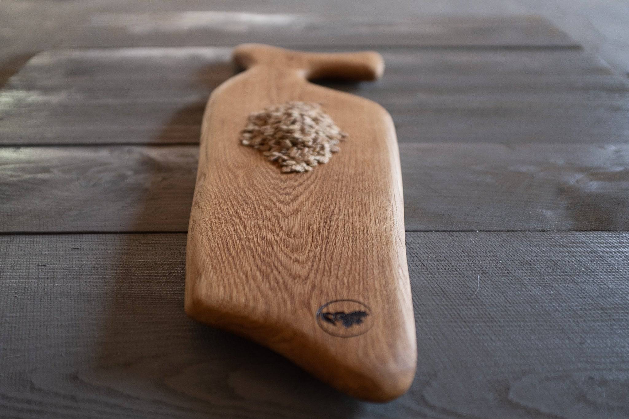 Nahaufnahe von dem Vorlegebrett mit Haferflocken auf Holz